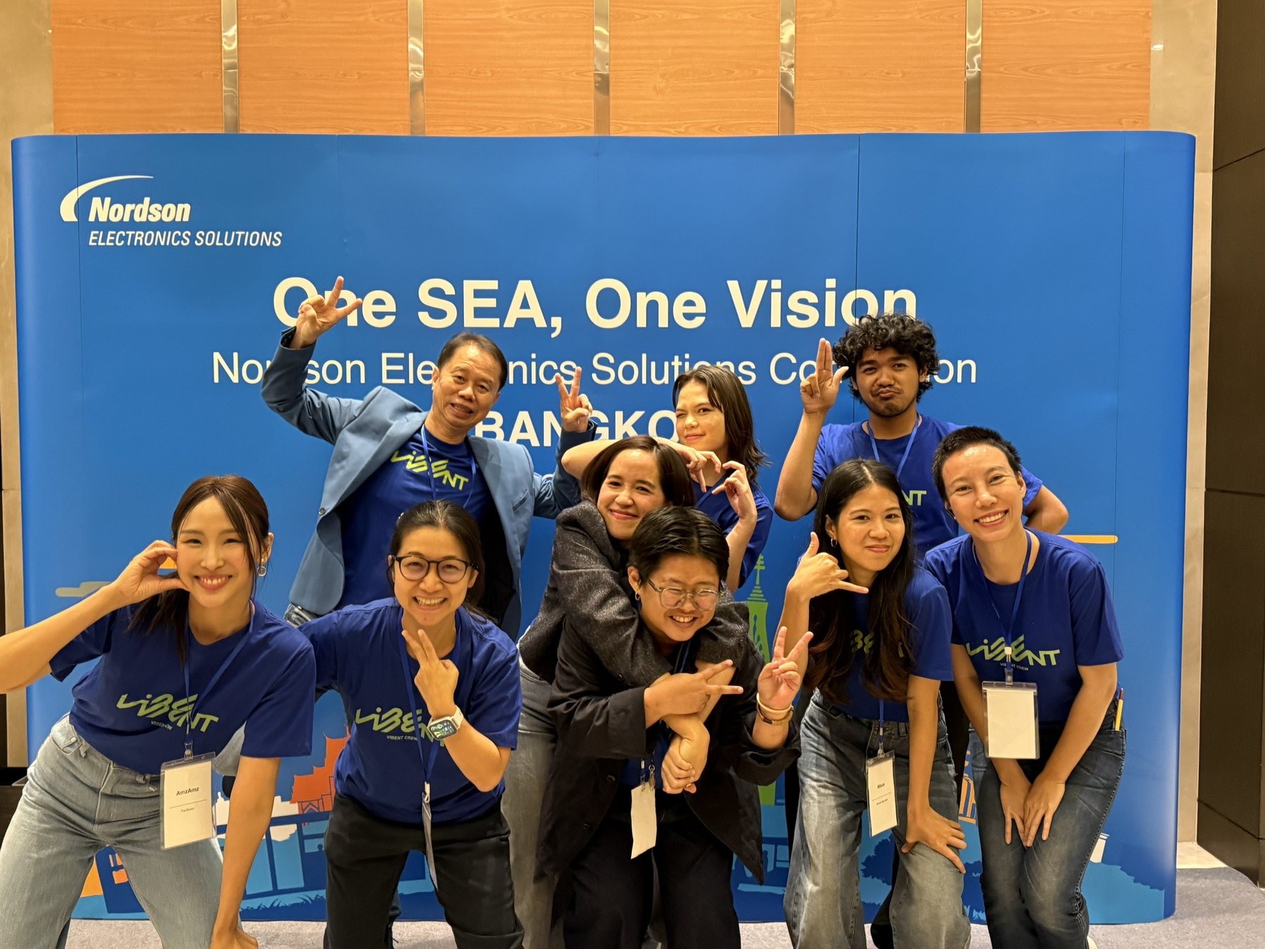 Vibent crew in front of client backdrop